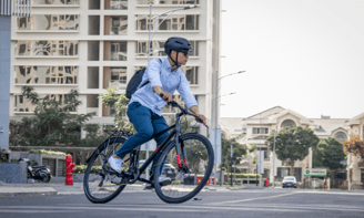 a man riding a bicycle on a city street