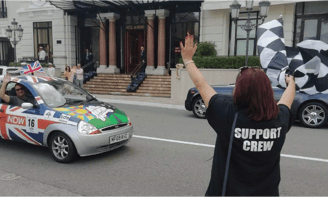 a woman waving a flag in a car