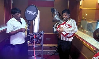 The Manohar Brass Band in a professional music recording studio, capturing their latest melodies.