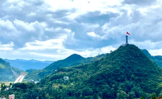 a flag flying over a mountain