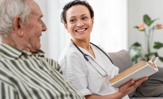 Healthcare worker smiling at an elderly patient