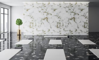 a room with a large marbled floor and a plant in the middle