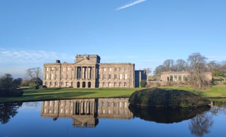 Grand mansion reflected in still water