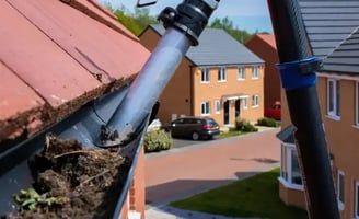 LEAVES BEING CLEANED OUT OF A GUTTERING ON A HOUSE BY keystone property care