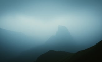 UniverseX - a mountain scene with a lone bird flying in the sky