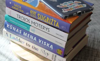 a stack of books with a kindle on top of them