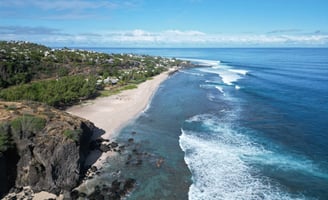 a beach with a sandy beach and a blue sky