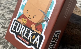 Eureka the mining card game deck on a rock table