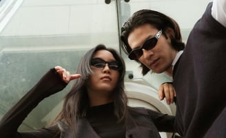 a man and woman in black suits and sunglasses