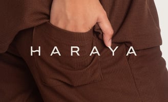 a person wearing a brown sweater and a brown pantsuitt