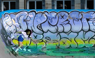 a skateboarder is riding her skateboard on a ramp