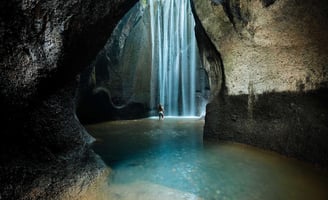 a person standing in front of a waterfall