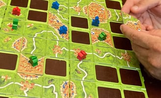 Getting ready to play a tile in Carcassonne the game