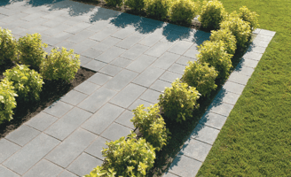 a garden with a brick wall and a brick wall