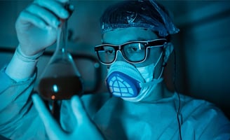 a man in a mask and glasses holding a pipe