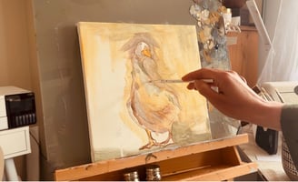 Alex working on a painting on canvas of a duck