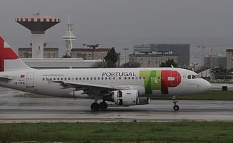 Portugal airlines- a plane with a colorful painted on it