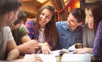 A group of students sitting together, studying or working on a project, representing the students