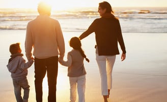 A family walking along a beach