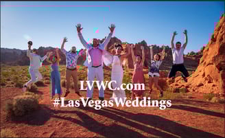 a group of people standing in front of a mountain