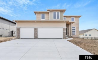 light brown two story home with 2 garages