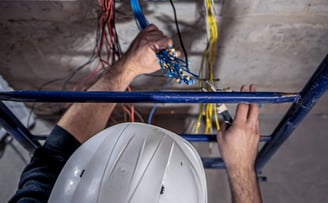 <a href="https://www.freepik.com/free-photo/male-electrician-works-switchboard-with-electrical-conne