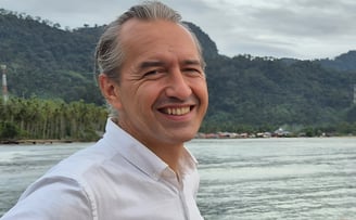 Photo of Rico Wallenta standing by the water in Sungai Pisang, West Sumatra
