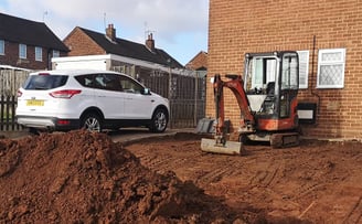 Mini digger in use for drainage work in Oldbury