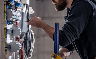 <a href="https://www.freepik.com/free-photo/male-electrician-works-switchboard-with-electrical-conne