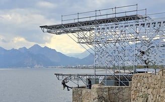 a man standing on a cliff face down into the ocean