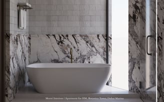 White tub in a bathroom with textured and Arabescato marble walls and a glass shower door.