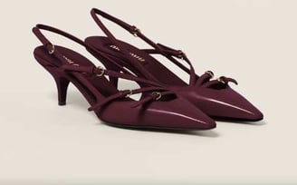 a pair of shoes with a bow tie on the side