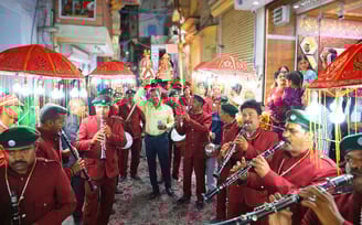 Manohar Brass Band, with their master in the middle, marching with Gangaur, exuding enthusiasm among the crowd.