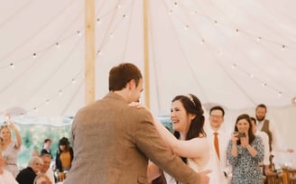 Wedding guests photographing bride and groom during their first dance