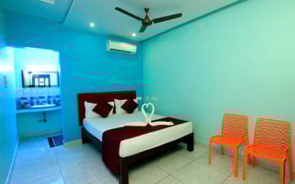 a bed room with a bed and two chairs