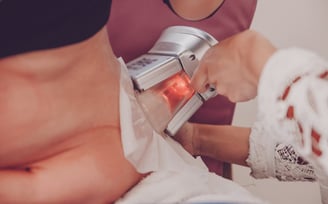 a woman having a cryolipolysis treatment at an aesthetic clinic