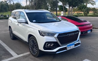 a white suv parked in a parking lot