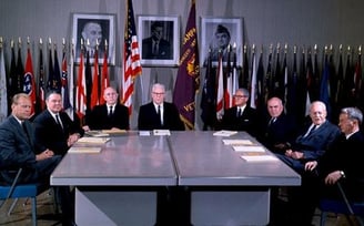 a group of men sitting around a table