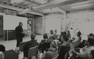 Martin Osner teaching a group of students in a workshop at the Photography School and Art Academy.