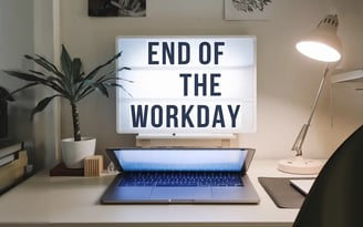 a laptop computer sitting on a desk with a lightbox and a lamp