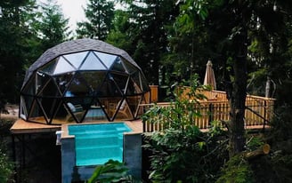 a dome shaped pool with a pool and a deck