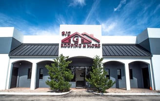 a building with a sign that says Big G Roofing 