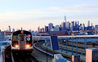 a train on the tracks in a city , in USA