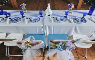 a table with a plate set and flower for a wedding