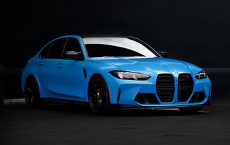 Electric blue BMW M3 Competition XDrive car photography at 704 Exotics in Charlotte, North Carolina.