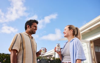 Product photography - a man and woman standing outside of a house