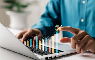 a man is pointing at a bar chart in a financial software