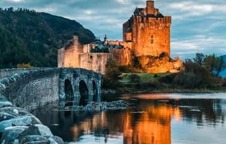 Castle at dusk with lights showing off the beautiful walls