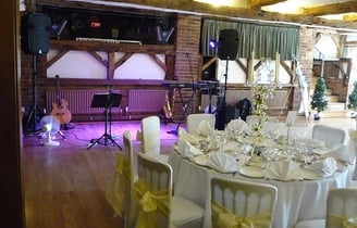 a wedding reception table with a saxophone and guitar