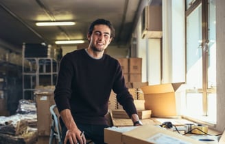 A man standing in a room with boxes of boxes